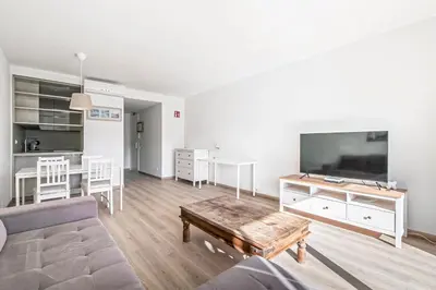 a living room with a couch and a flat screen tv at Tango in Sitges