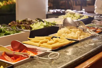 a buffet with many different types of food on a counter at Checkin Garbí in Calella