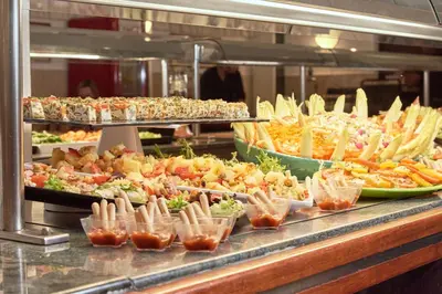 a buffet line with many different types of food at Checkin Garbí in Calella