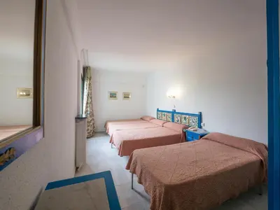 a row of beds in a room at Checkin Garbí in Calella