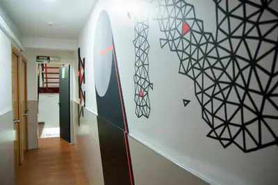 a hallway with a wall with a painting on it at Be Ramblas Guest House in Barcelona