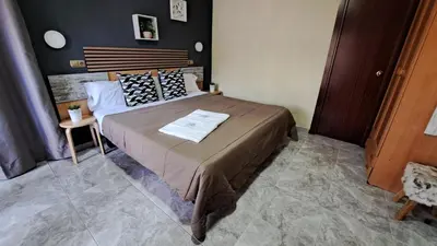 a bedroom with a large bed in a room at Hotel Rodsan Suizo in Castelldefels