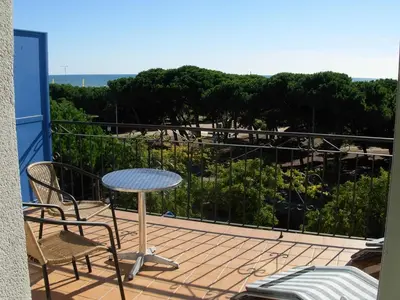 a patio with a table and chairs on a balcony at Hotel Rodsan Suizo in Castelldefels