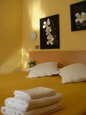 a group of towels sitting on top of a bed at Hotel Rodsan Suizo in Castelldefels