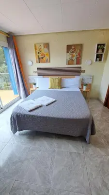 a bedroom with a bed with two towels on it at Hotel Rodsan Suizo in Castelldefels