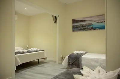 a bedroom with two beds and a mirror at Barcelona City Ramblas in Barcelona