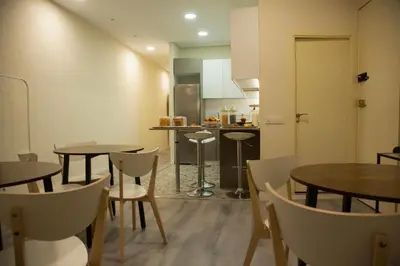 a kitchen and dining room with tables and chairs at Barcelona City Ramblas in Barcelona