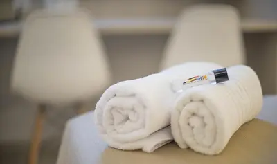 a roll of toilet paper sitting on top of a bed at Sono House in La Garriga