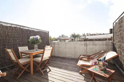 a patio with a table and chairs on a balcony at Apartment Barcelona Rentals - Penthouse with Terrace in Barcelona