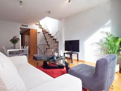 a living room with a white couch and a table at Apartment Barcelona Rentals - Penthouse with Terrace in Barcelona