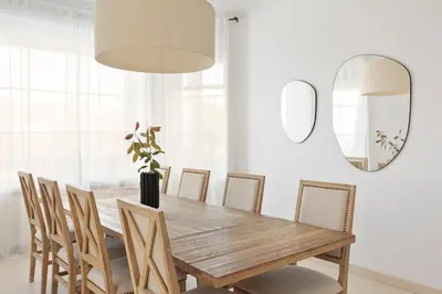 a bedroom with a large white bed and a chair at Luxury Seaview Villa by Olala Homes in Teià