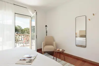 a balcony with chairs and a view of a pool at Luxury Seaview Villa by Olala Homes in Teià