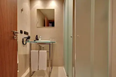 a bathroom with a sink and a mirror at Hotel Badalona Tower in Badalona