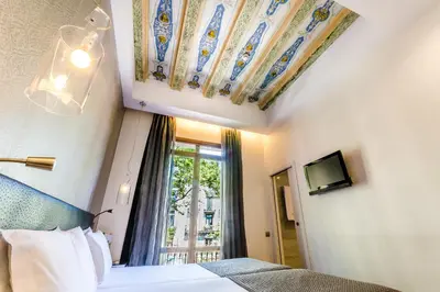 a hotel room with a bed and a window at Dorma Ramblas Boquería in Barcelona