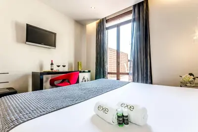 a hotel room with a bed and a window at Dorma Ramblas Boquería in Barcelona