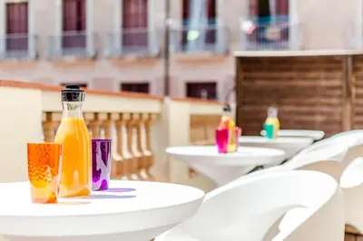 a group of tables with bottles of drinks on them at Dorma Ramblas Boquería in Barcelona