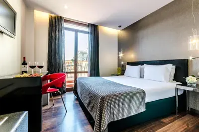 a hotel room with a bed and a window at Dorma Ramblas Boquería in Barcelona