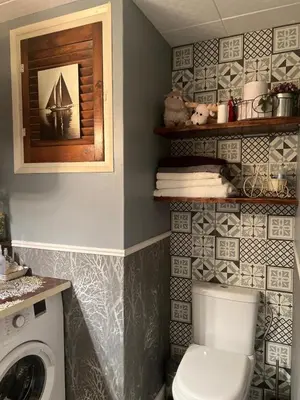 a bathroom with a toilet and a washing machine at Apartment Oliver in Calella