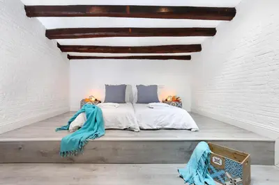 a bedroom with a bed in a white room at Gracia 1872 in Barcelona