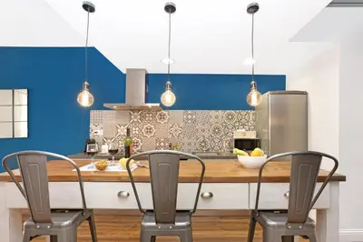 a kitchen with a wooden table and two chairs at Gracia 1872 in Barcelona
