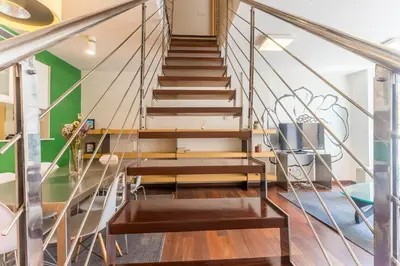 a staircase in a home with wooden floors and metal railings at Apartment Barcelona Rentals - Swimming Pool with Terrace in Barcelona