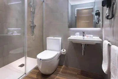a bathroom with a toilet and a sink and a shower at Hostal Operaramblas in Barcelona