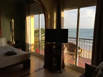 a bedroom with a bed and a view of the ocean at Sitges Beach Panorama in Sitges