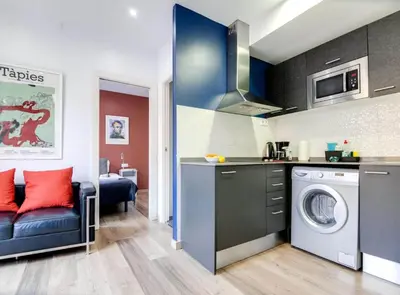 a kitchen with a washing machine in a room at City&Beach Apartments in City Center in Barcelona