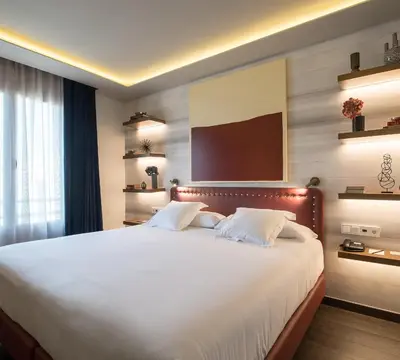 a bedroom with a large bed with white sheets at Vincci Mae in Barcelona
