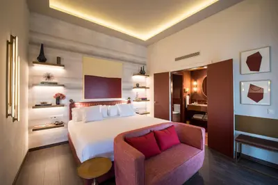a hotel room with a bed and a chair at Vincci Mae in Barcelona
