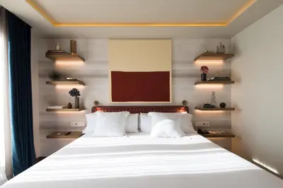 a bedroom with a large bed with white pillows at Vincci Mae in Barcelona