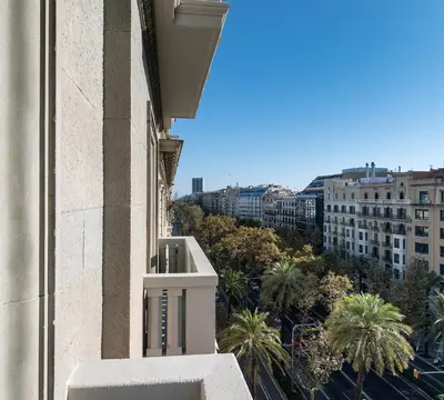 a view from the balcony of a building with palm trees at Vincci Mae in Barcelona