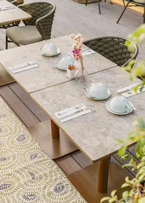 a wooden table with plates and napkins on it at Vincci Mae in Barcelona