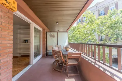 a patio with chairs and a table on a balcony at Apartment Barcelona Rentals - Classic Bonanova Apartment in Barcelona