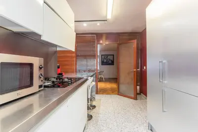 a kitchen with white counters and a refrigerator at Apartment Barcelona Rentals - Classic Bonanova Apartment in Barcelona