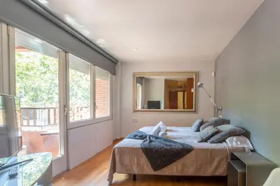 a bedroom with a bed and a mirror at Apartment Barcelona Rentals - Classic Bonanova Apartment in Barcelona