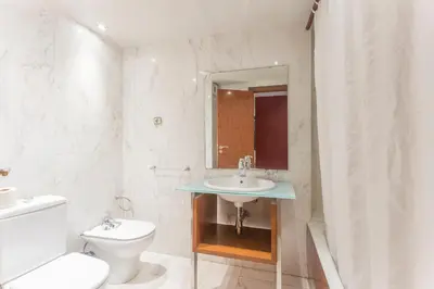 a white bathroom with a sink and a toilet at Apartment Barcelona Rentals - Classic Bonanova Apartment in Barcelona