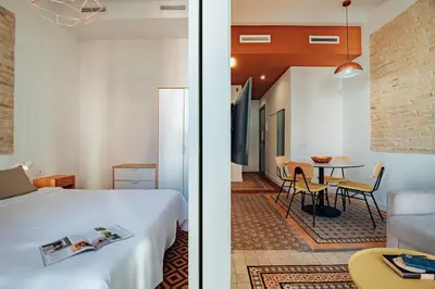 a bedroom and a living room with a bed and a table at Design Apartments by Olala Homes in Hospitalet de Llobregat