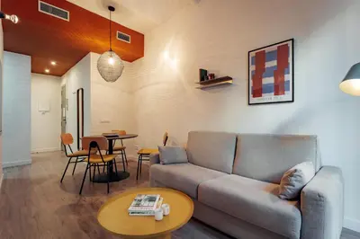 a living room with a couch and a table at Design Apartments by Olala Homes in Hospitalet de Llobregat