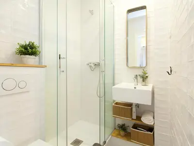 a bathroom with a glass shower and a sink at Cozy Gracia 2 bedrooms in Barcelona