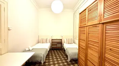 a bedroom with a large bed with red pillows at Suites4days Plaça Catalunya Design in Barcelona