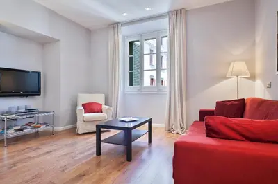 a living room with a red couch and a table at Bonavista Apartments - Passeig de Gracia in Barcelona