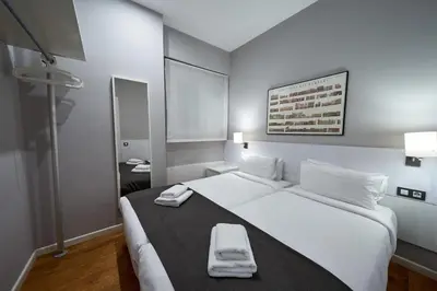 a bedroom with a large white bed with two towels on it at Bonavista Apartments - Passeig de Gracia in Barcelona