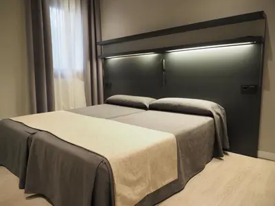 a bedroom with two beds in a room at Hostal Benidorm in Barcelona