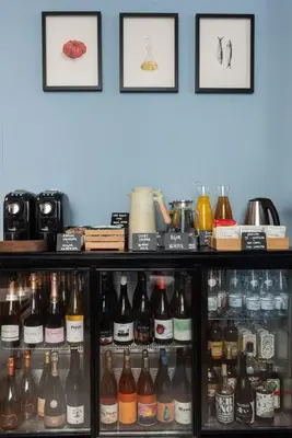 a shelf filled with lots of different types of bottles at Hotel La Casa Del Sol in Barcelona
