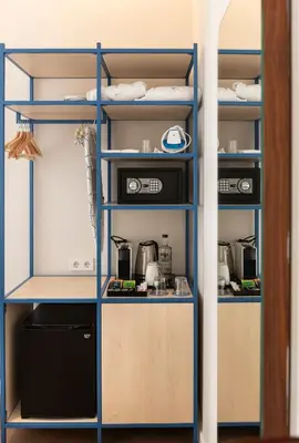 a kitchen with blue shelving at Hotel La Casa Del Sol in Barcelona