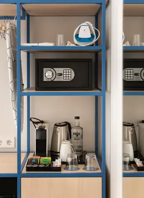 a kitchen pantry with a blue shelf with appliances at Hotel La Casa Del Sol in Barcelona