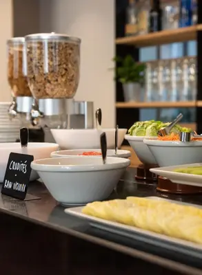 a buffet with bowls of food on a table at Hotel La Casa Del Sol in Barcelona