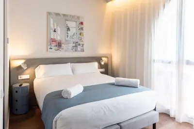 a bedroom with a bed with two towels on it at Hotel La Casa Del Sol in Barcelona