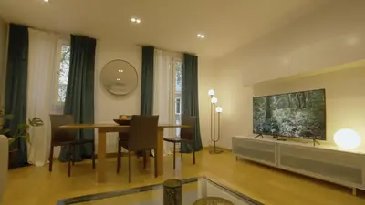 a living room with a dining table and a flat screen tv at Sarriá - Sant Gervasi in Barcelona